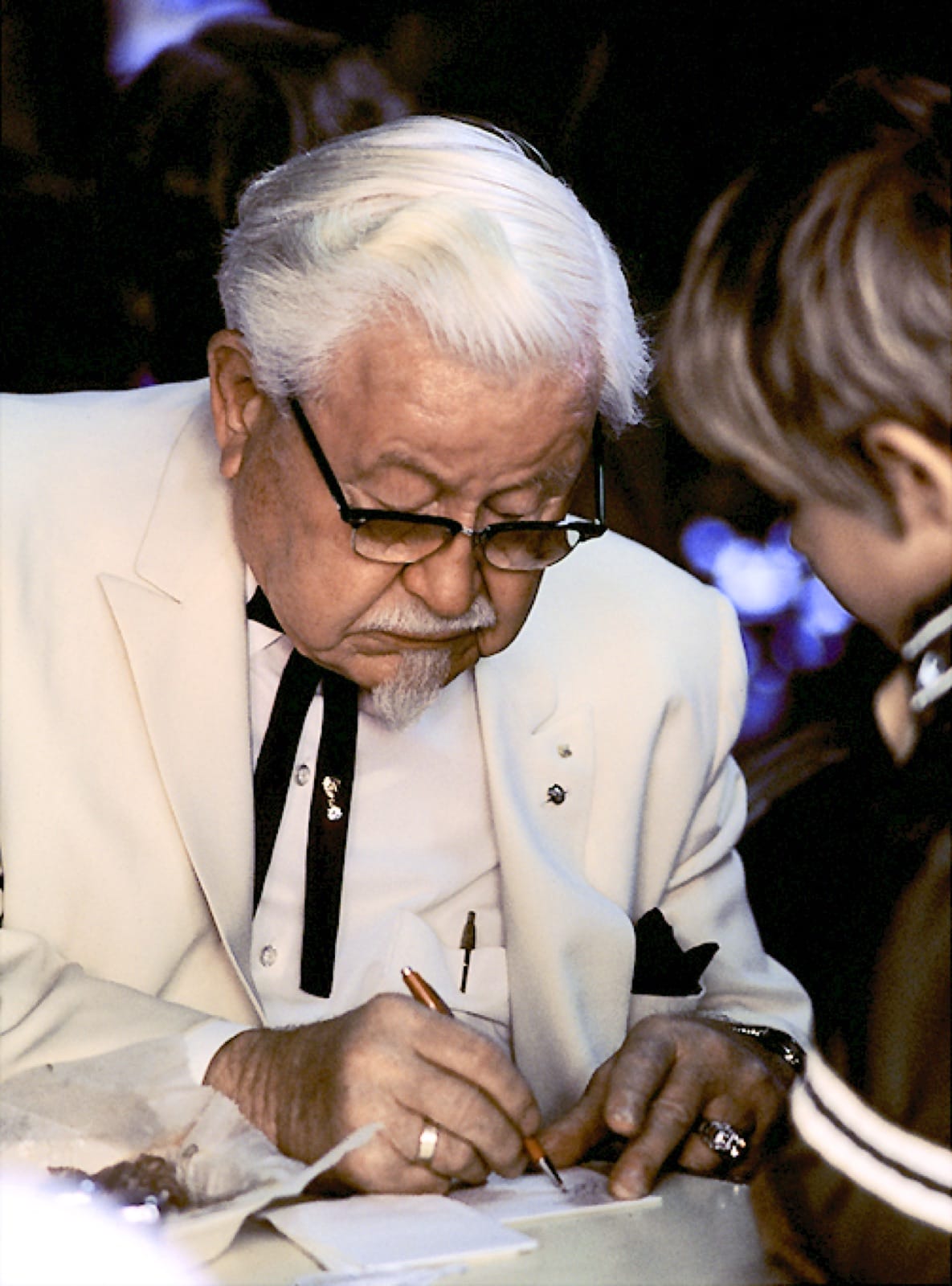 Colonel Harland Sanders in character — the documented founder, now used as a mascot